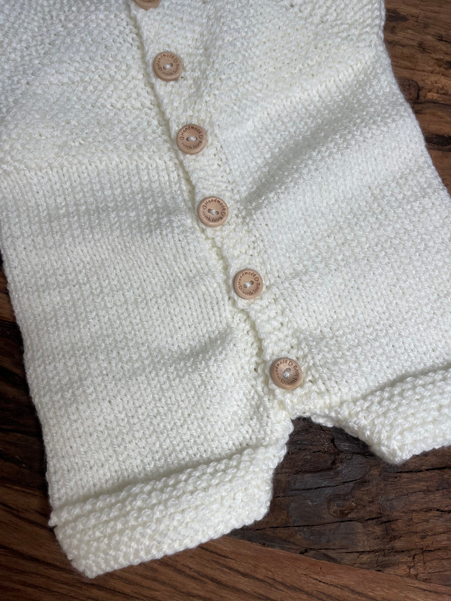 Hand knitted button up newborn romper